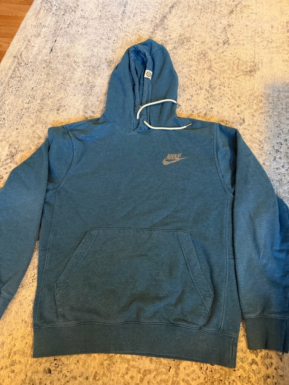 Nike Revival fleece pullover hoodie in a washed blue color.